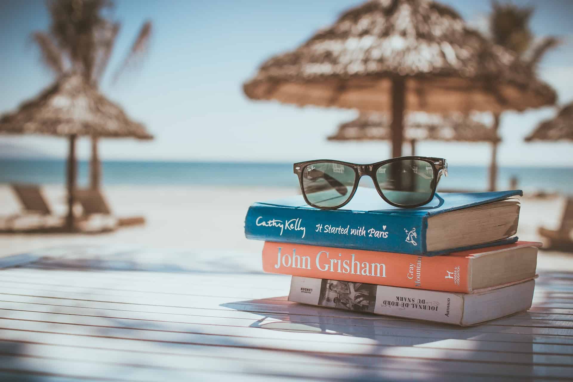 tropical vacation with books and sunglasses