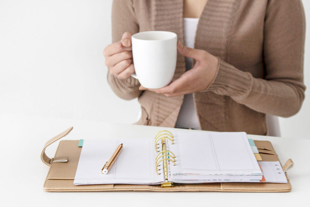 Woman goal setting while drinking coffee