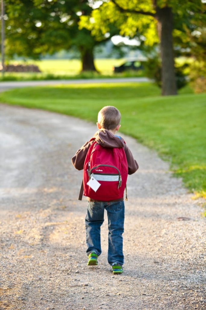 boy with backpack how to save money on back to school shopping